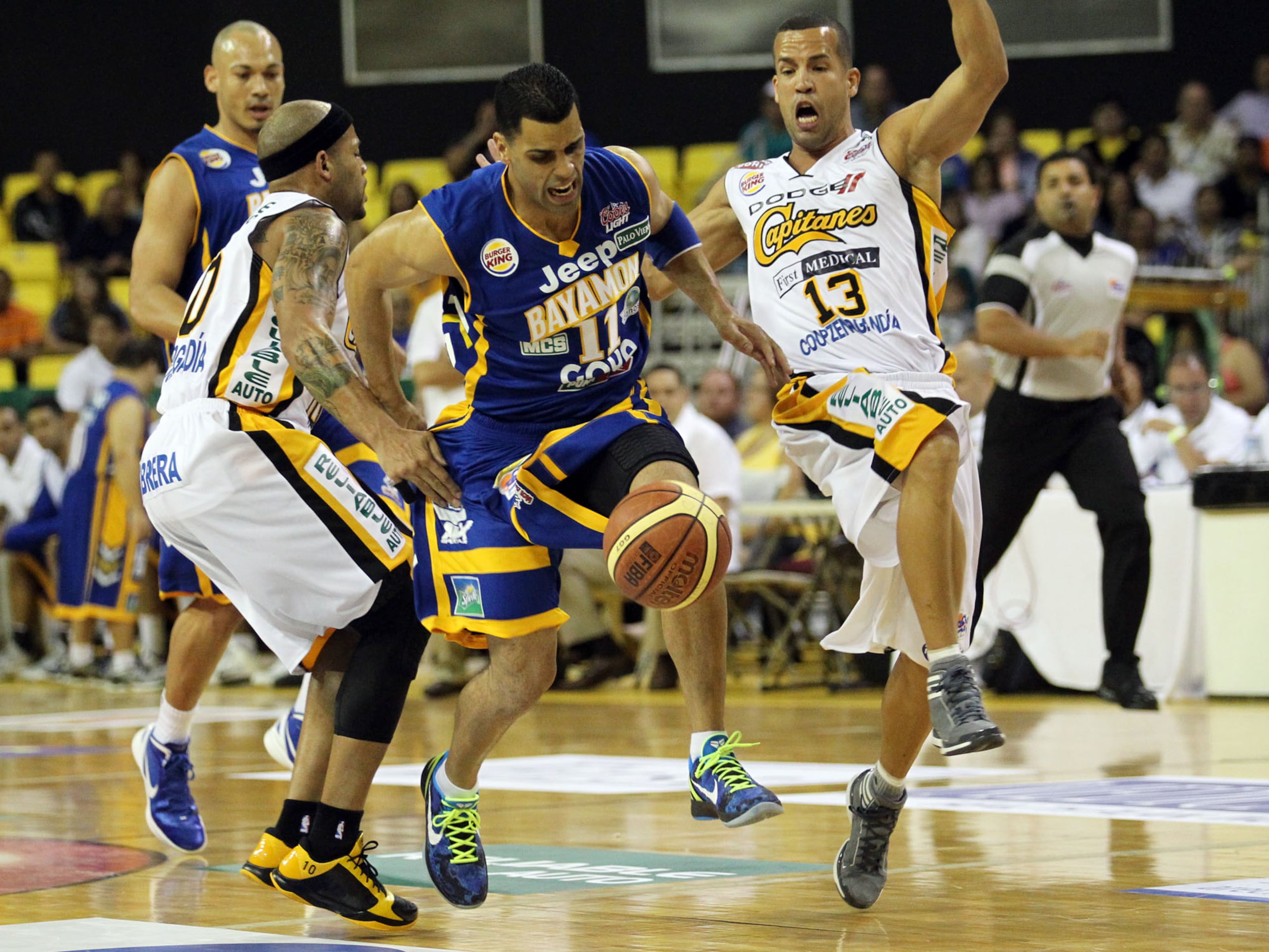 Christian Dalmau (11) y Rafael "Pachy" Cruz (13), enfrentados en un partido entre los Vaqueros de Bayamón y los Capitanes de Arecibo.