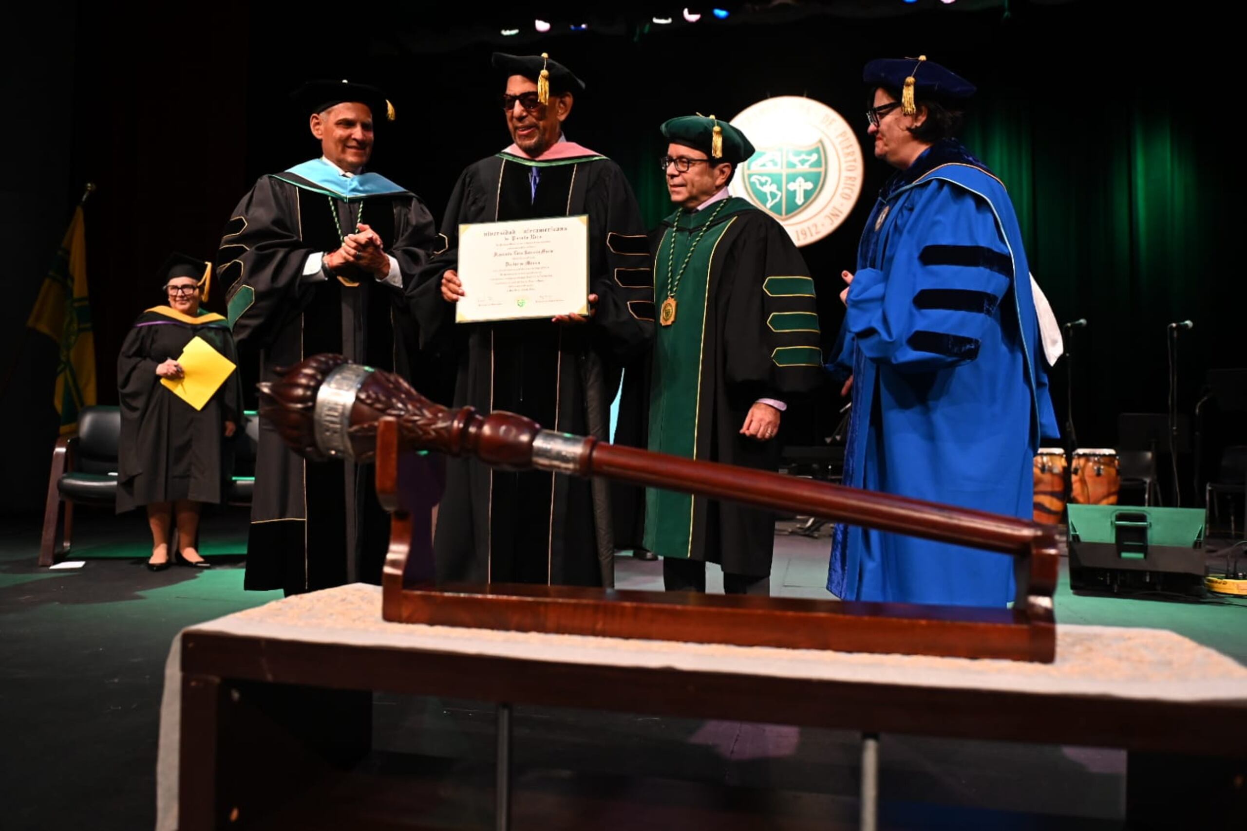 El director musical muestra emocionado el diploma con el grado honorífico de Doctorado en Música en compañía del doctor Rafael Ramíez Rivera, presidente de la Interamericana; Domingo Mas, presidente de la Junta de Síndicos, y la doctora Jacqueline Álvarez Peña, vicepresidenta de Asuntos Académicos y Estudiantiles de la institución.