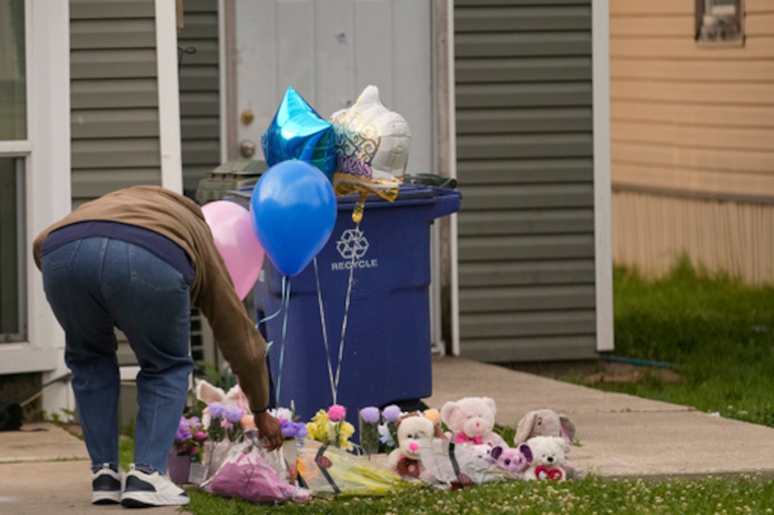 Una persona deja un regalo en un monumento improvisado en el jardín delantero de la casa donde los niños fueron asesinados durante un tiroteo masivo el día anterior en Shreveport, La., Lunes, 20 de abril 2026. (AP Photo/Gerald Herbert)