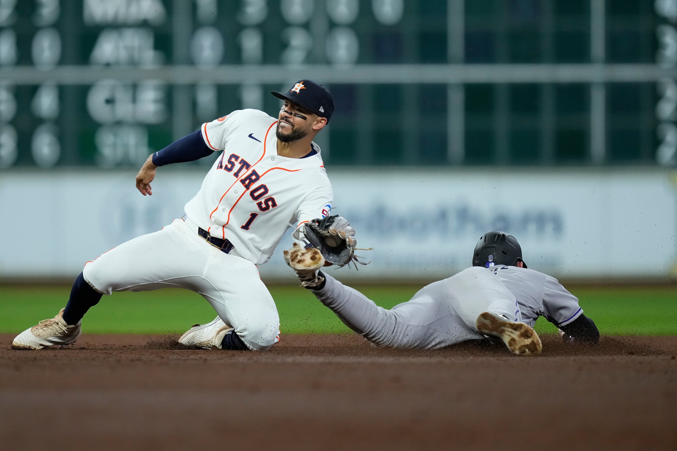 Carlos Correa atrapa a Brenton Doyle mientras intentaba robarse una base en un juego entre los Astros de Houston y los Rockies de Colorado.