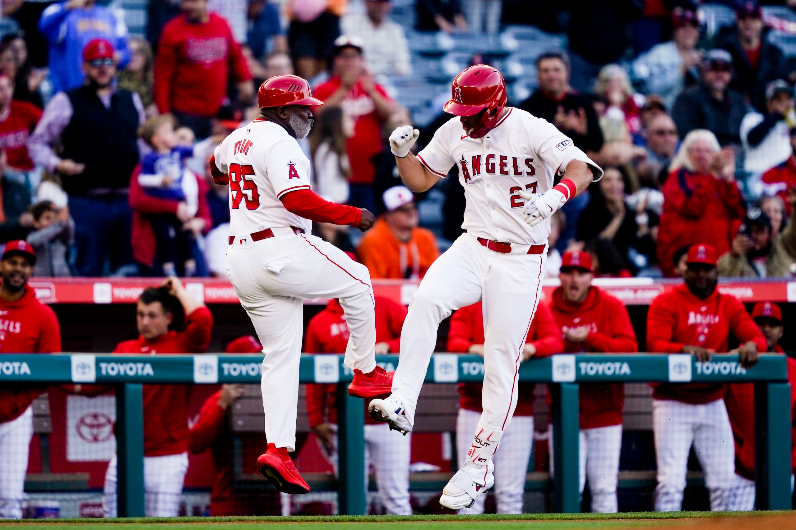 Mike Trout (derecha) festeja con Eric Young, coach de la antesala de los Angelinos de Los Ángeles, luego de batear un jonrón en el juego del martes 23 de abril de 2024 ante los Orioles de Baltimore.