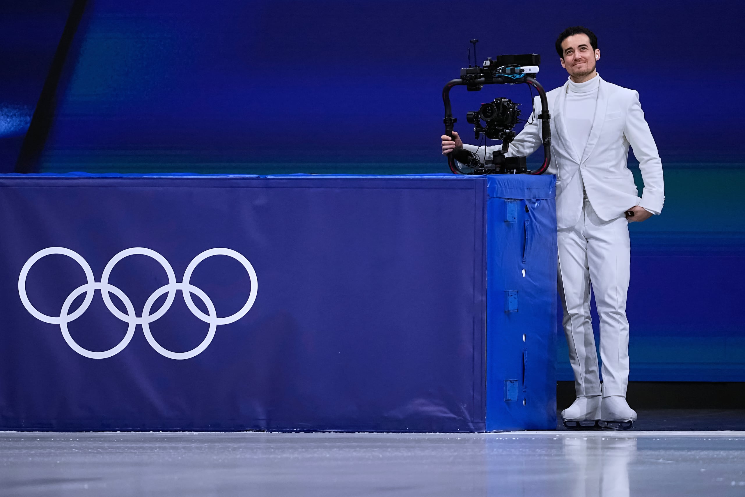 Jordan Cowan opera la cámara antes del programa corto de patinaje artístico por parejas en los Juegos Olímpicos de Invierno de 2026, en Milán, Italia, el domingo 15 de febrero de 2026. (Foto AP/Ashley Landis)