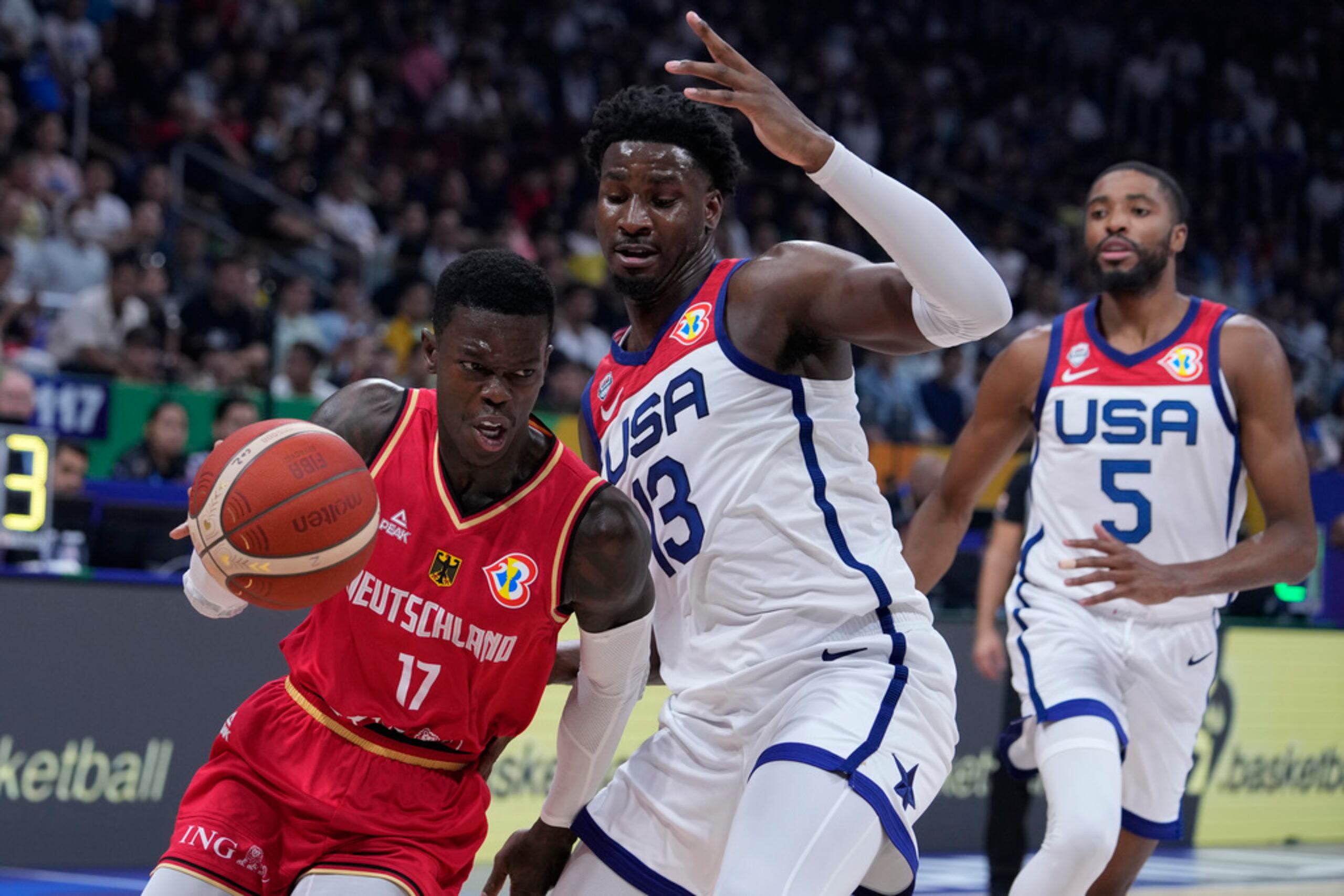 El alemán Dennis Schröder avanza con el balón superando al alero de Estados Unidos Jaren Jackson Jr en el encuentro de semifinales de la Copa Mundial de baloncesto en Manila.
