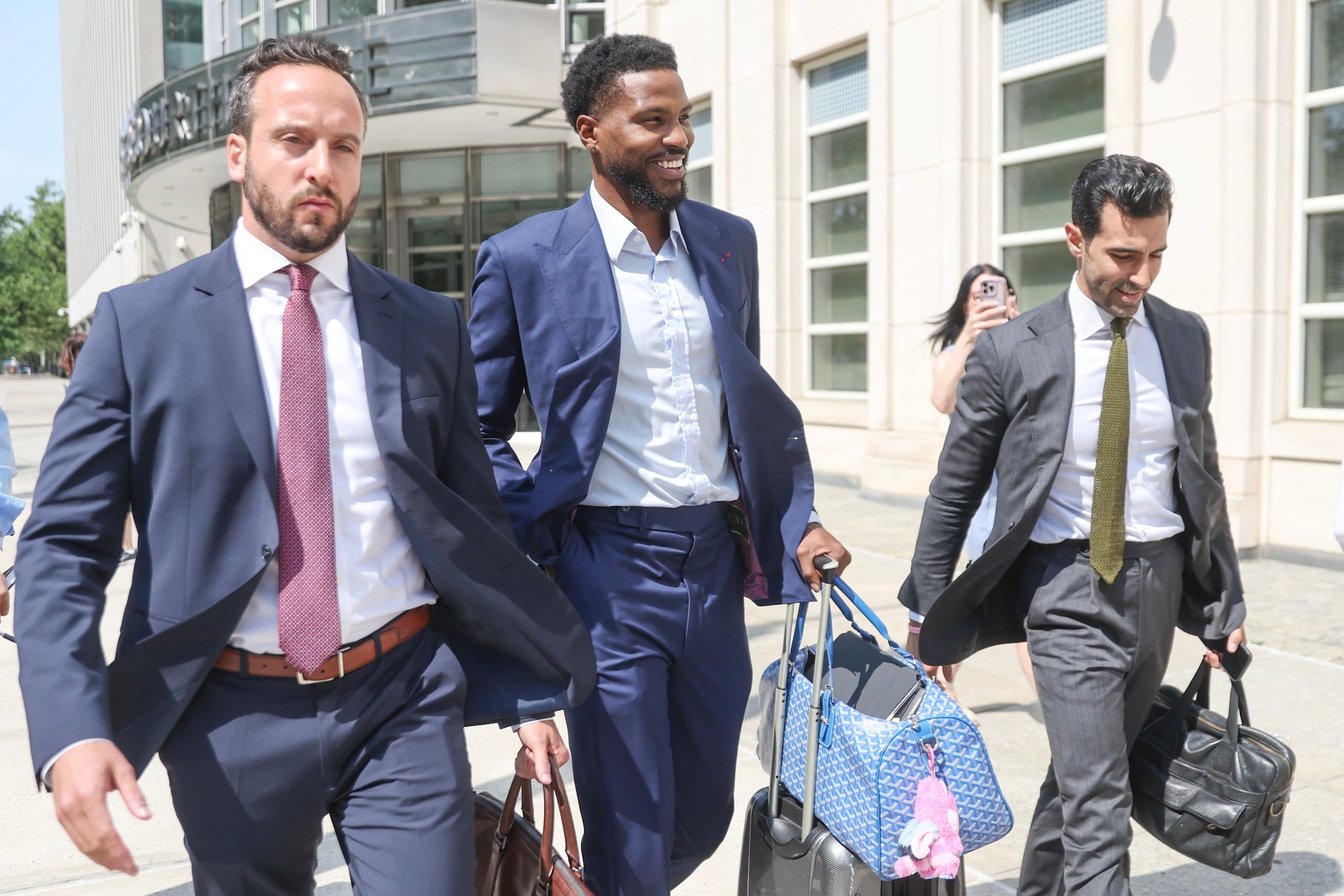 Malik Beasley, al centro, sale del tribunal federal de Brooklyn, Nueva York.