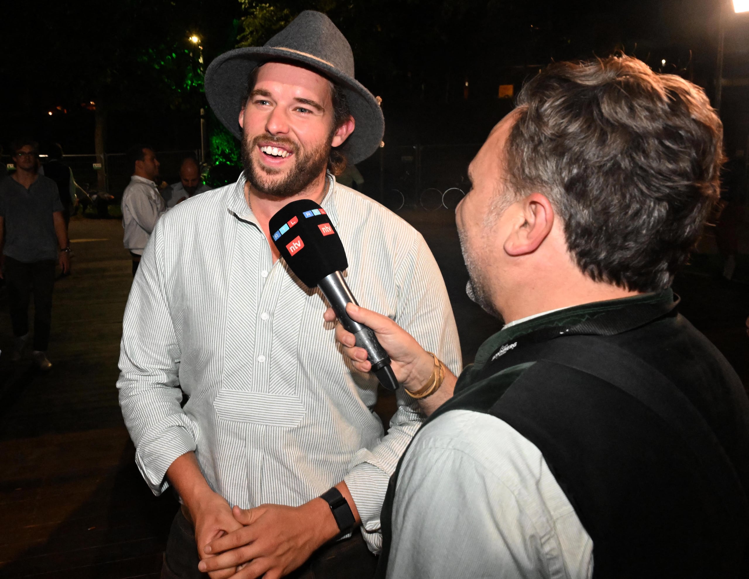 21 September 2023, Bavaria, Munich: Christopher Schwarzenegger (l), Arnold Schwarzenegger's son, gives an interview with his father in front of the Marstall tent after visiting the Wiesn. The 188th Wiesn will take place this year from 16.09.- 03.10.2023. Photo: Felix H�rhager/dpa (Photo by Felix H�rhager / DPA / dpa Picture-Alliance via AFP)