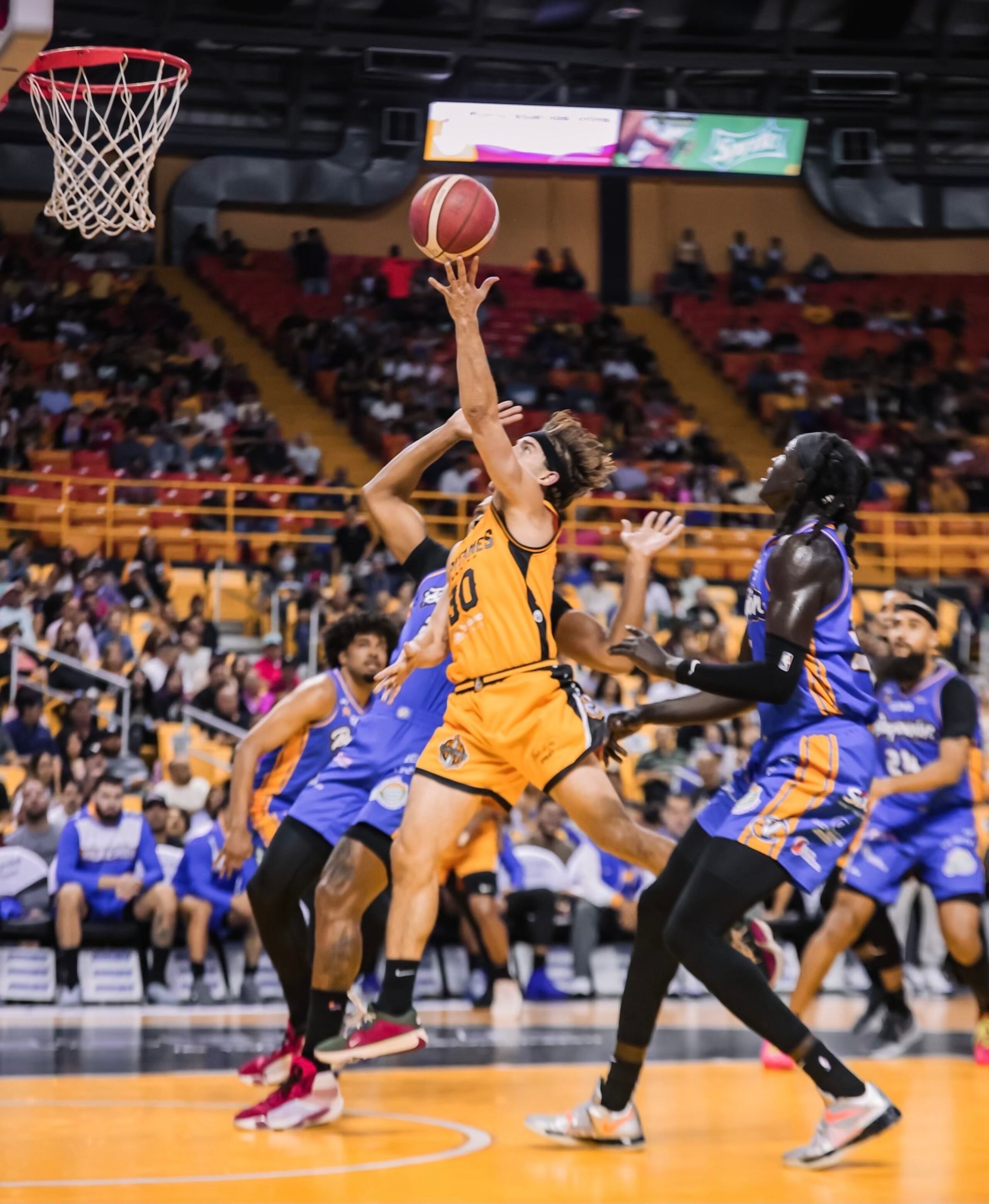 David Stockton, de los Capitanes de Arecibo, ataca el canasto ante la defensa de los Vaqueros de Bayamón.