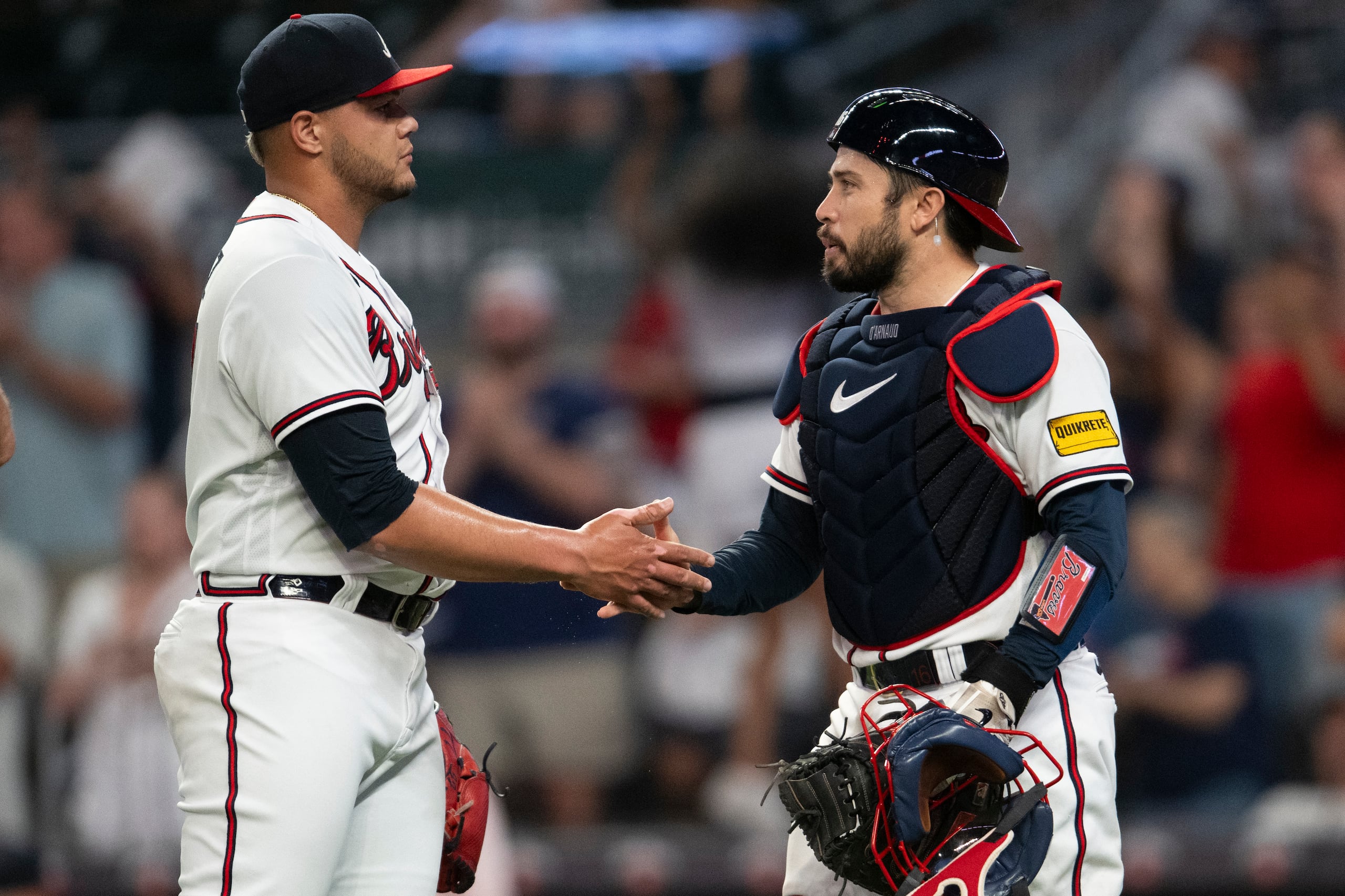 Joe Jiménez y el receptor de los Braves, Travis d'Arnaud, estrechan manos al cierre de un partido de esta semana ante los Yankees.