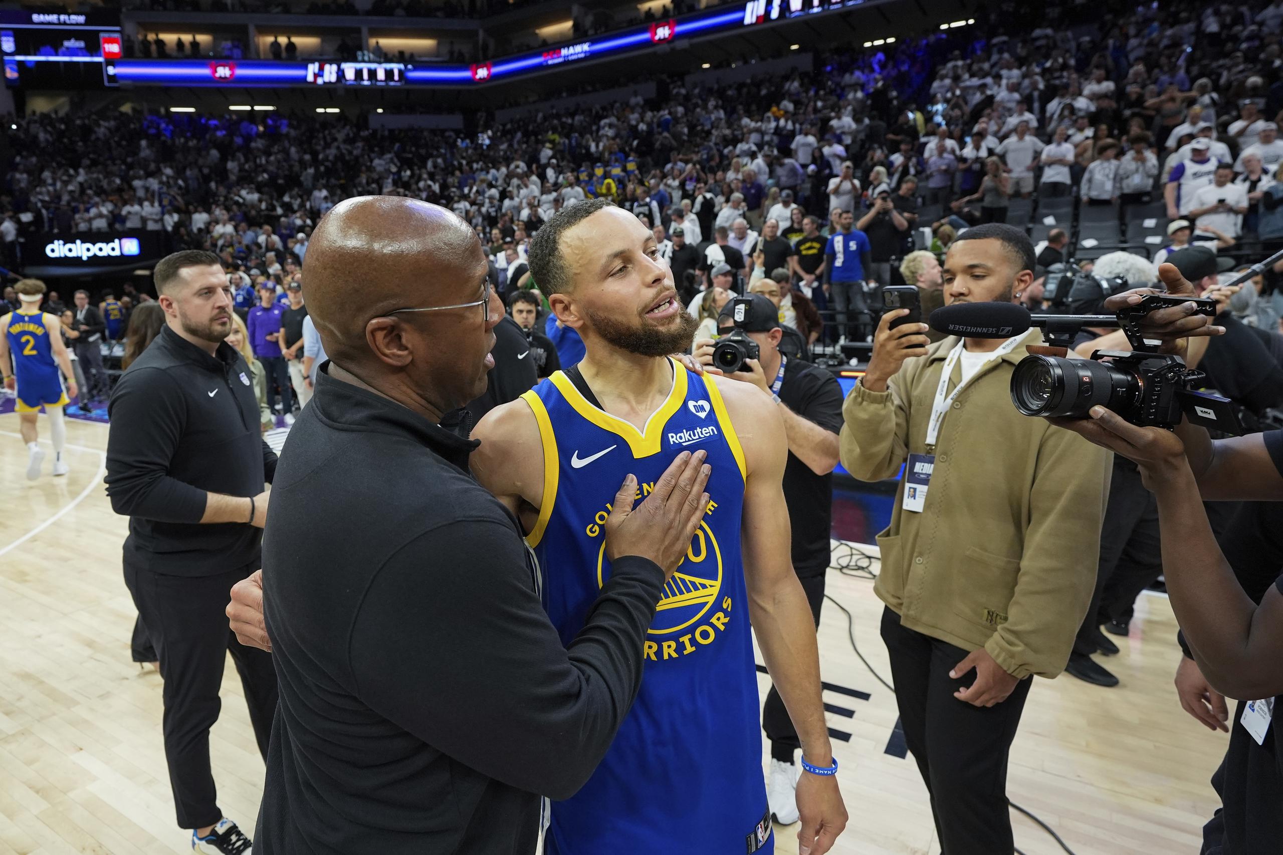 Mike Brown, entrenador de los Kings y exasistente de  los Warriors, consuela a Stephen Curry luego de eliminarlo.