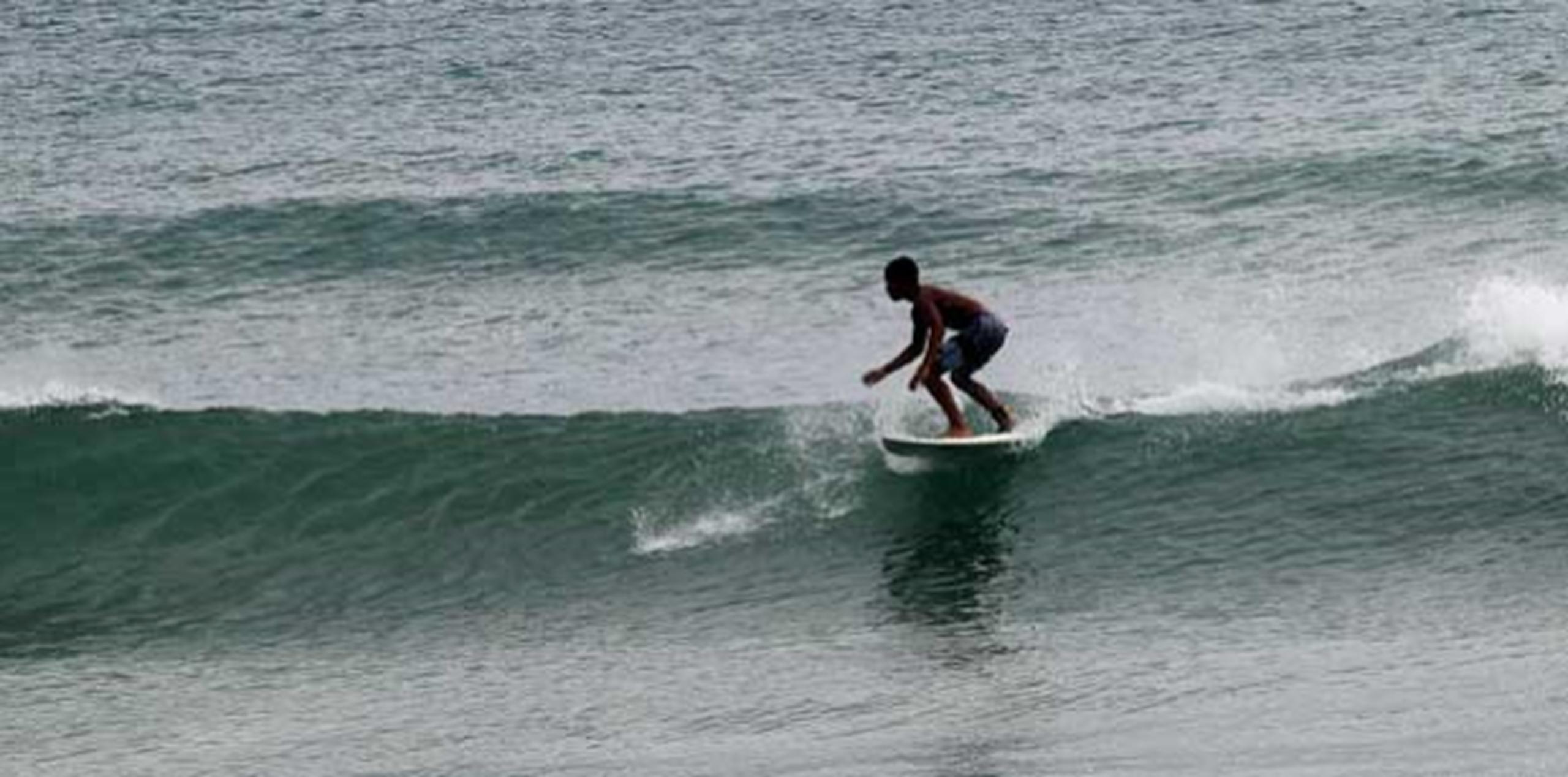 Un surfer llegó a eso de las 7:00 de la mañana de hoy hasta la playa Caza y Pesca, en Islote, Arecibo, para practicar el deporte que conoció cuando apenas tenía cinco años. (Para Primera Hora/ Nelson Reyes)