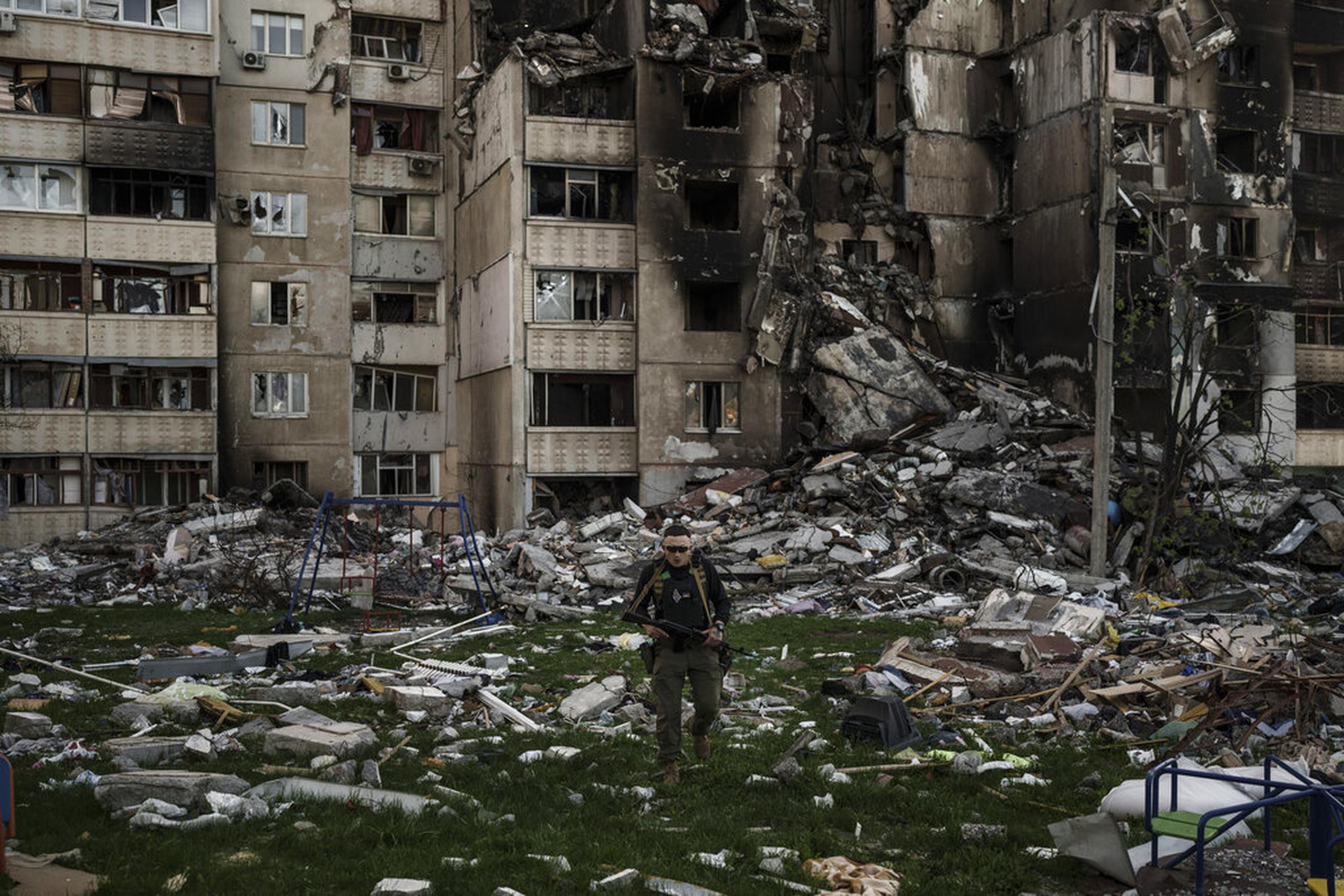 Un militar ucraniano camina entre los escombros de un edificio gravemente dañado por bombardeos rusos el 25 de abril de 2022, en Járkiv, Ucrania.