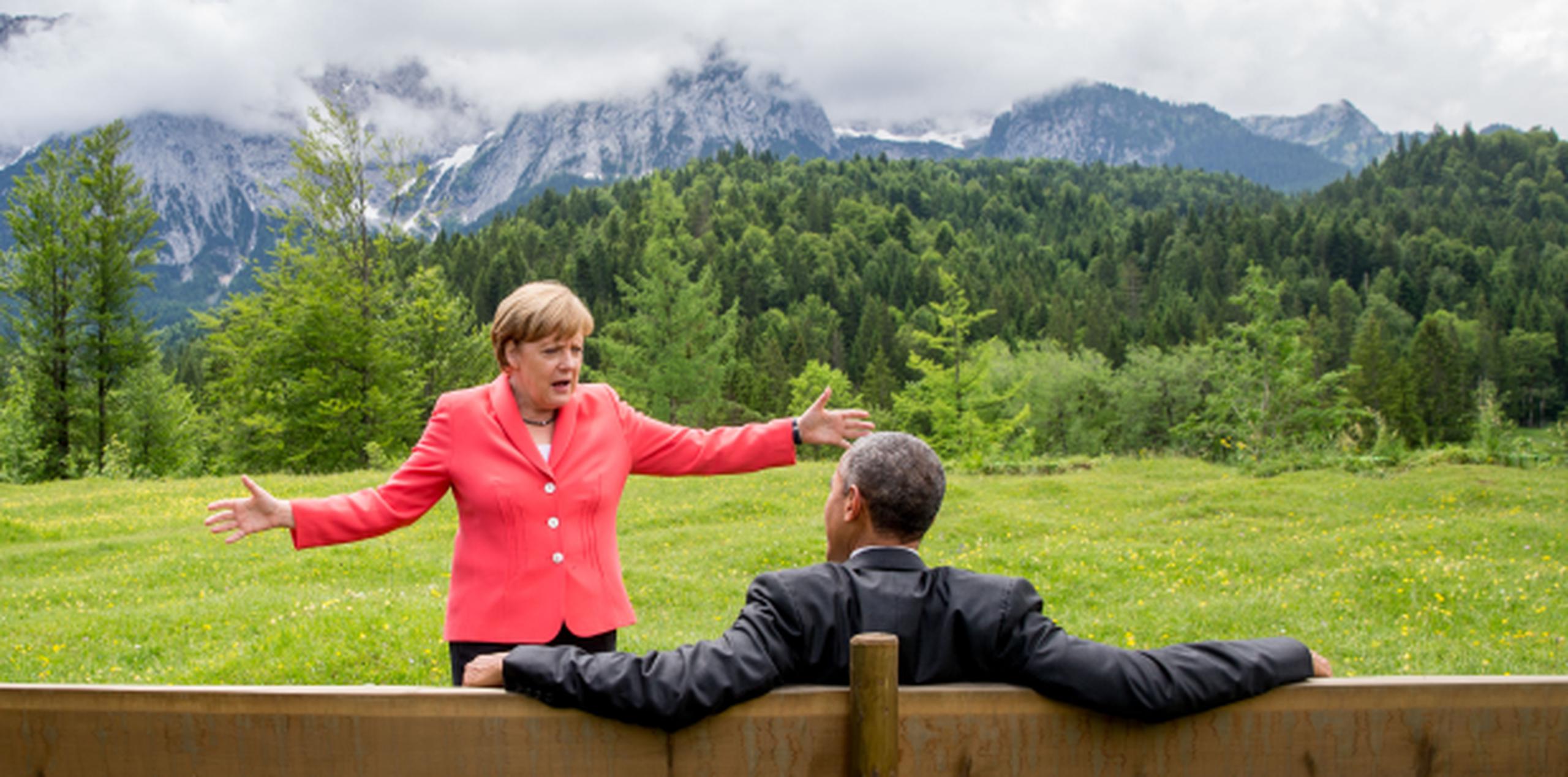 La canciller de Alemania, Angela Merkel, conversa animadamente con el presidente Barack Obama, en un aparte de la reunión en Alemania. (AP)